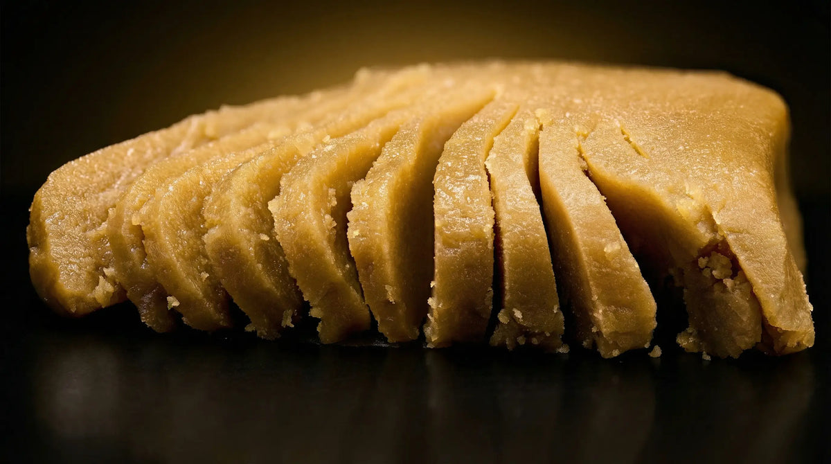 Sliced golden hash block with granular texture on dark background